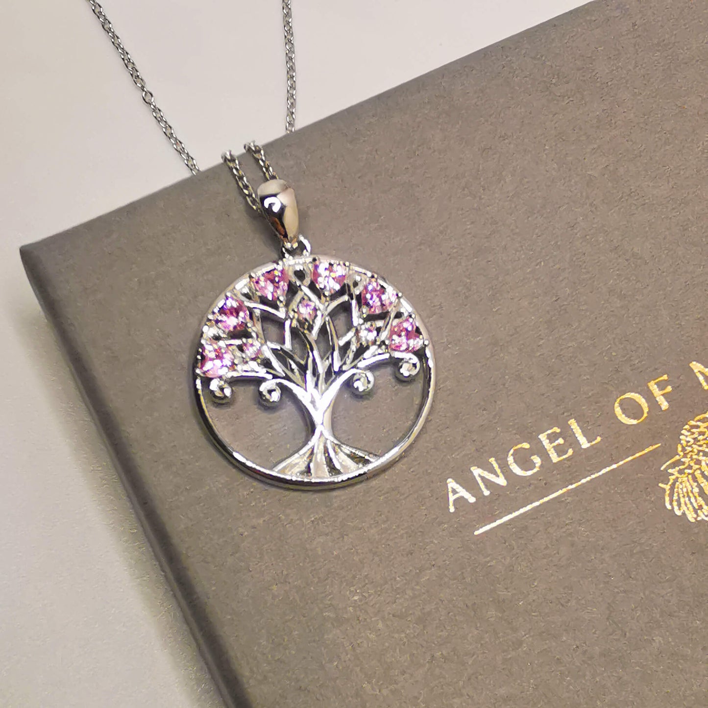 925 sterling silver tree of life pendant necklace featuring pink zircon stones. Beautiful unique and meaningful gift for family.