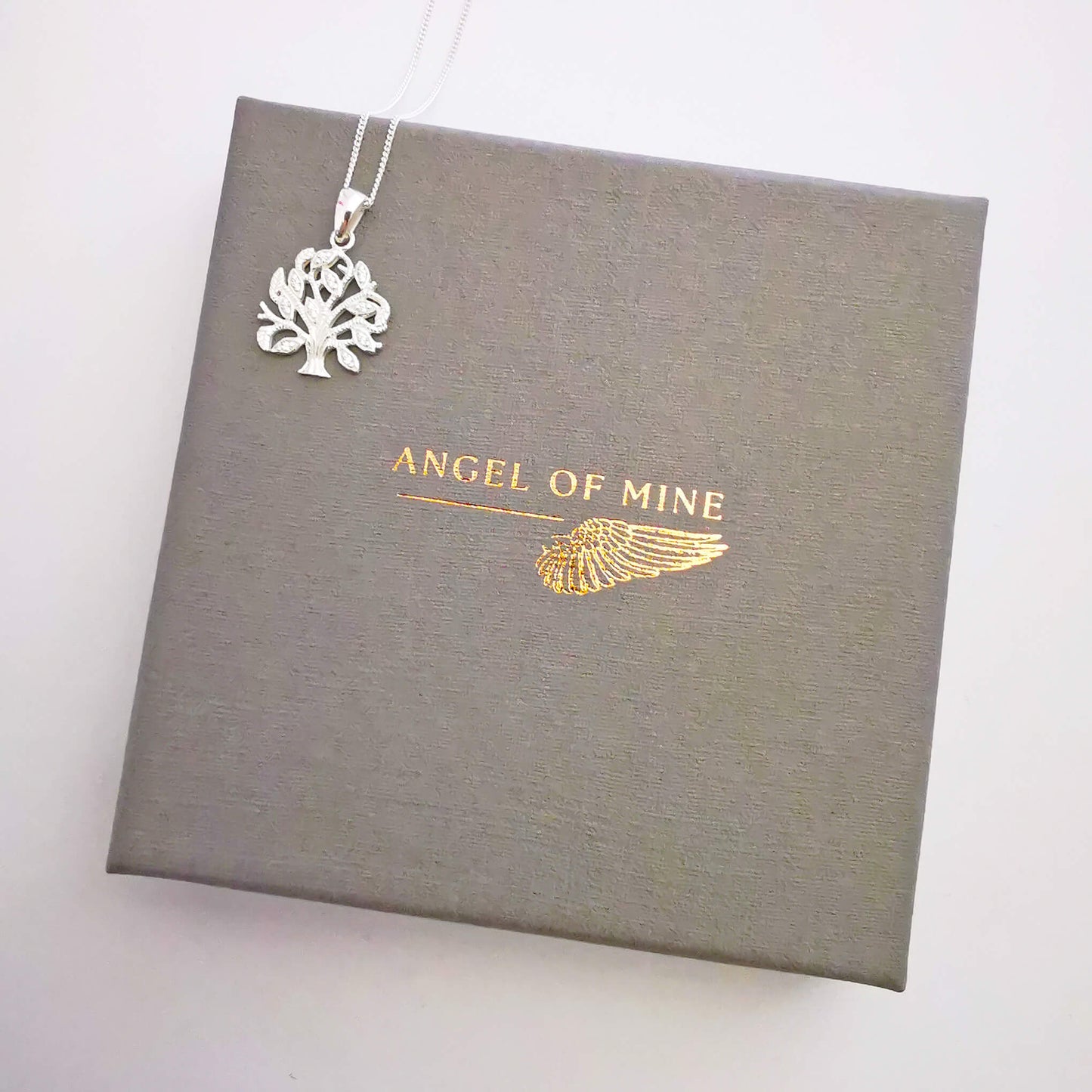 925 sterling silver minimalist tree of life pendant necklace with micro zirconia detailing. This unique gift is presented gift boxed with a handmade hand embellished insert featuring the quote: Family - where life begins and love never ends". Perfect gift for mum, sister, aunt or grandmother.