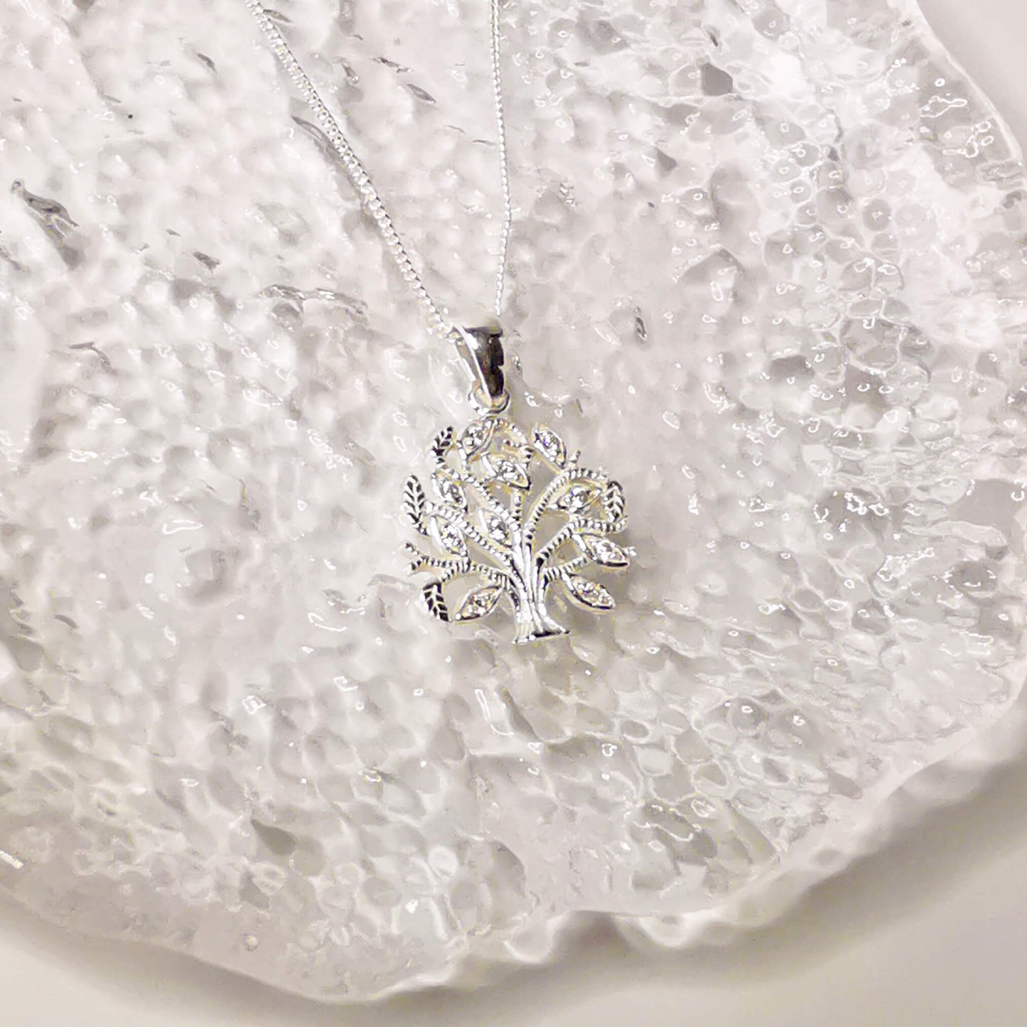 925 sterling silver minimalist tree of life pendant necklace with micro zirconia detailing. This unique gift is presented gift boxed with a handmade hand embellished insert featuring the quote: Family - where life begins and love never ends". Perfect gift for mum, sister, aunt or grandmother.