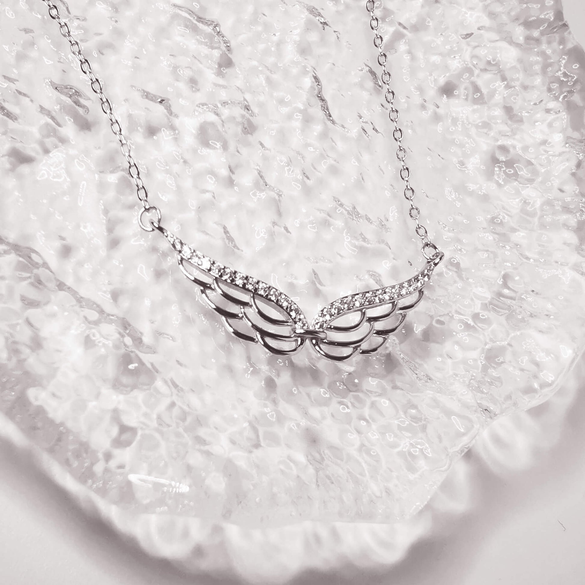 stunning sterling silver double wing necklace with micro zirconia.  Detailed angel wing. Perfect unique loss memorial gift.