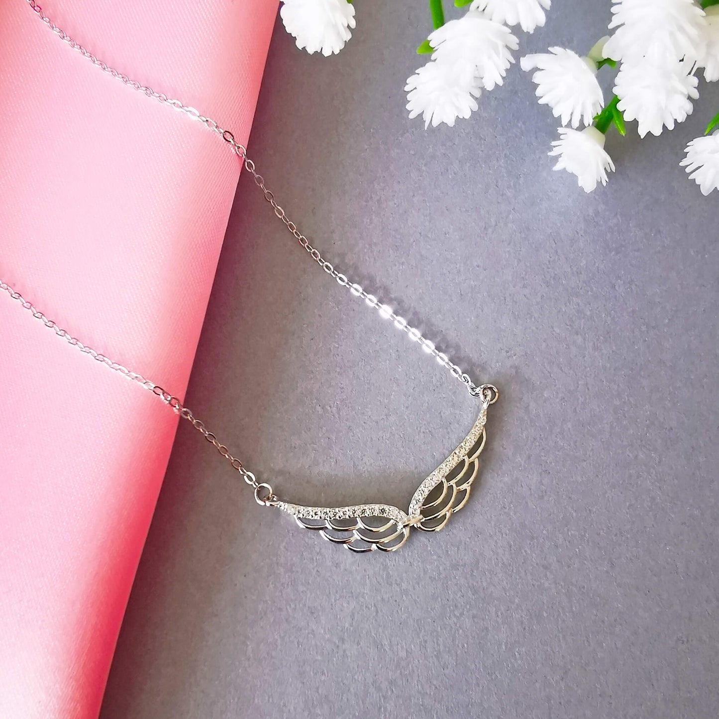 stunning sterling silver double wing necklace with micro zirconia.  Detailed angel wing. Perfect unique loss memorial gift.