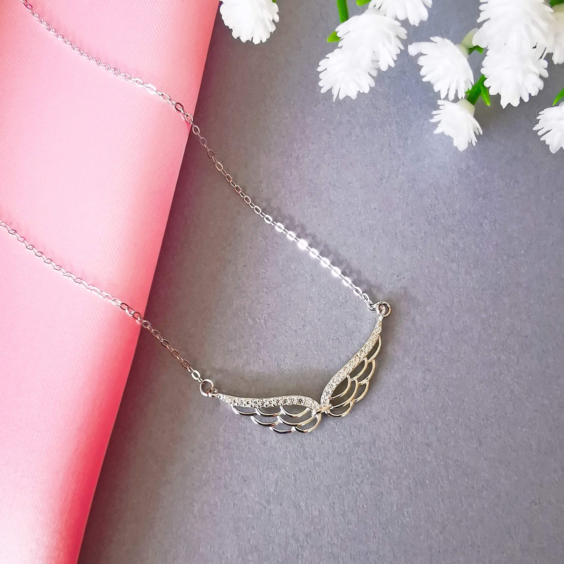 stunning sterling silver double wing necklace with micro zirconia.  Detailed angel wing. Perfect unique loss memorial gift.