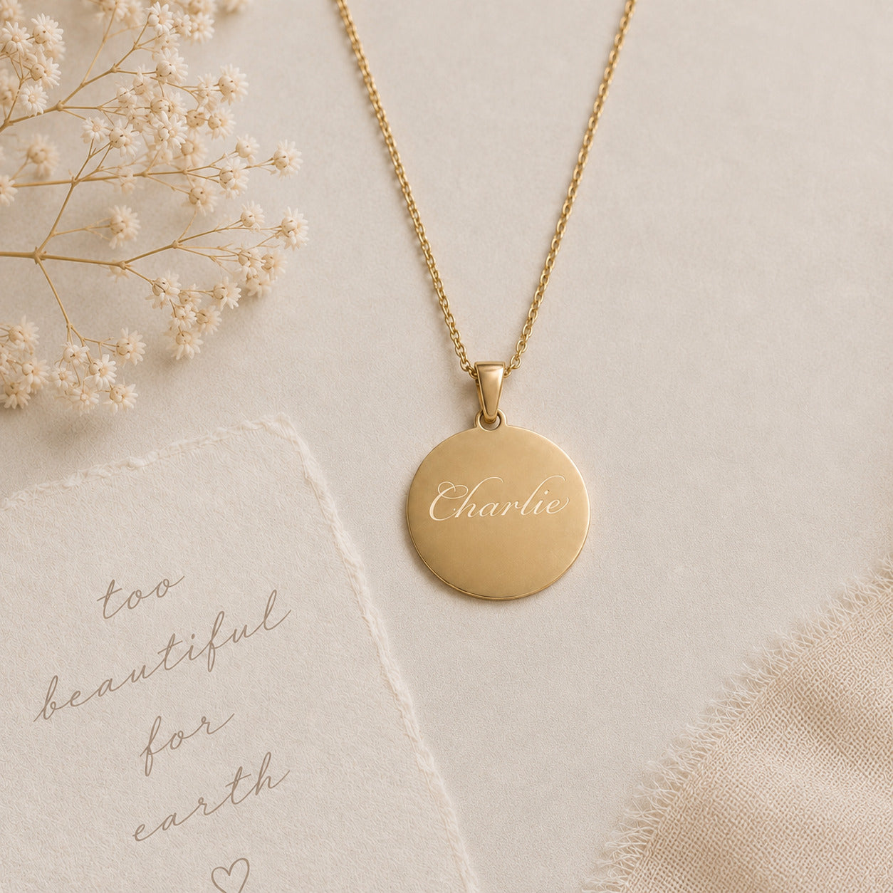 Gold necklace with a round pendant on a light background with text