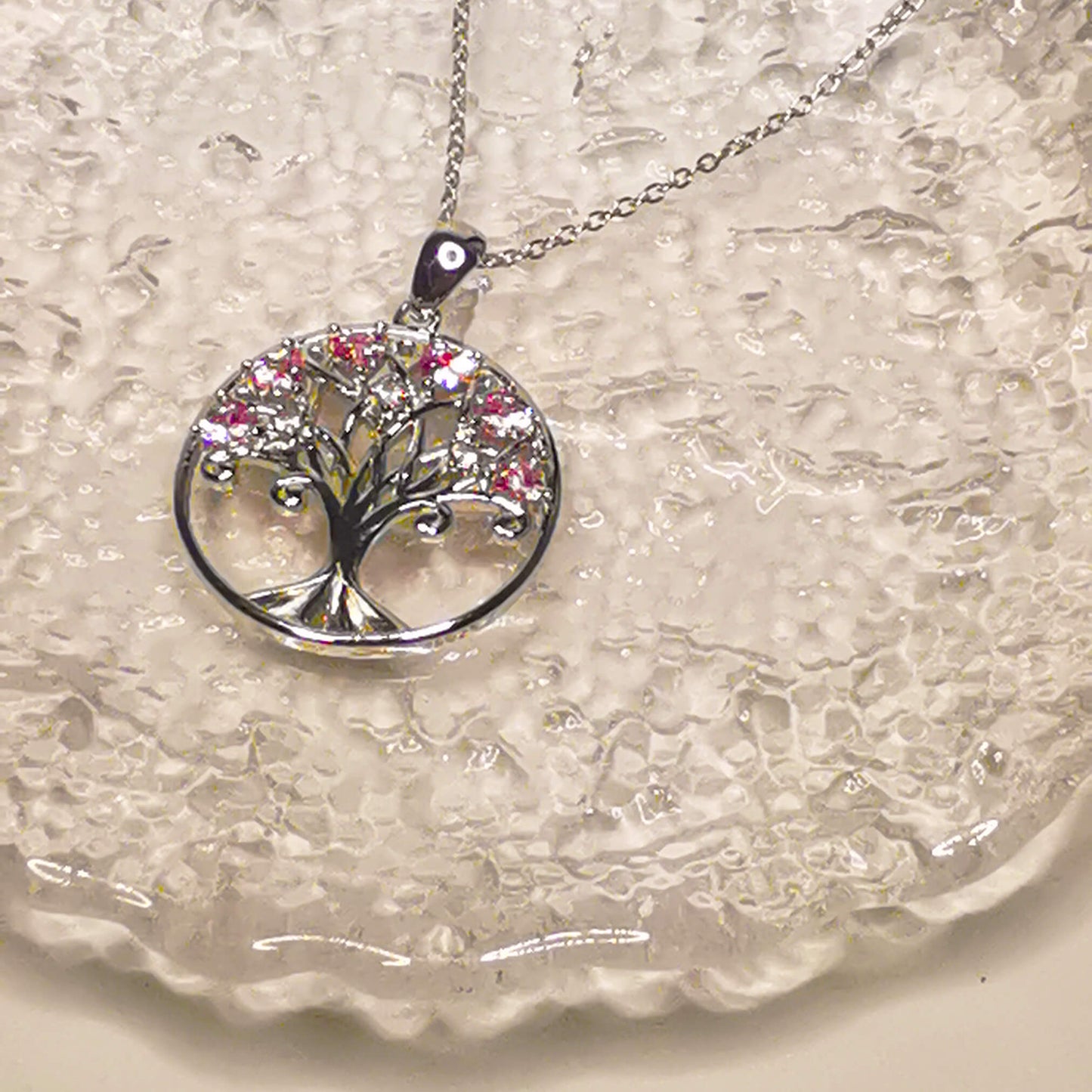 925 sterling silver tree of life pendant necklace featuring pink zircon stones.   Beautiful unique and meaningful gift for family.