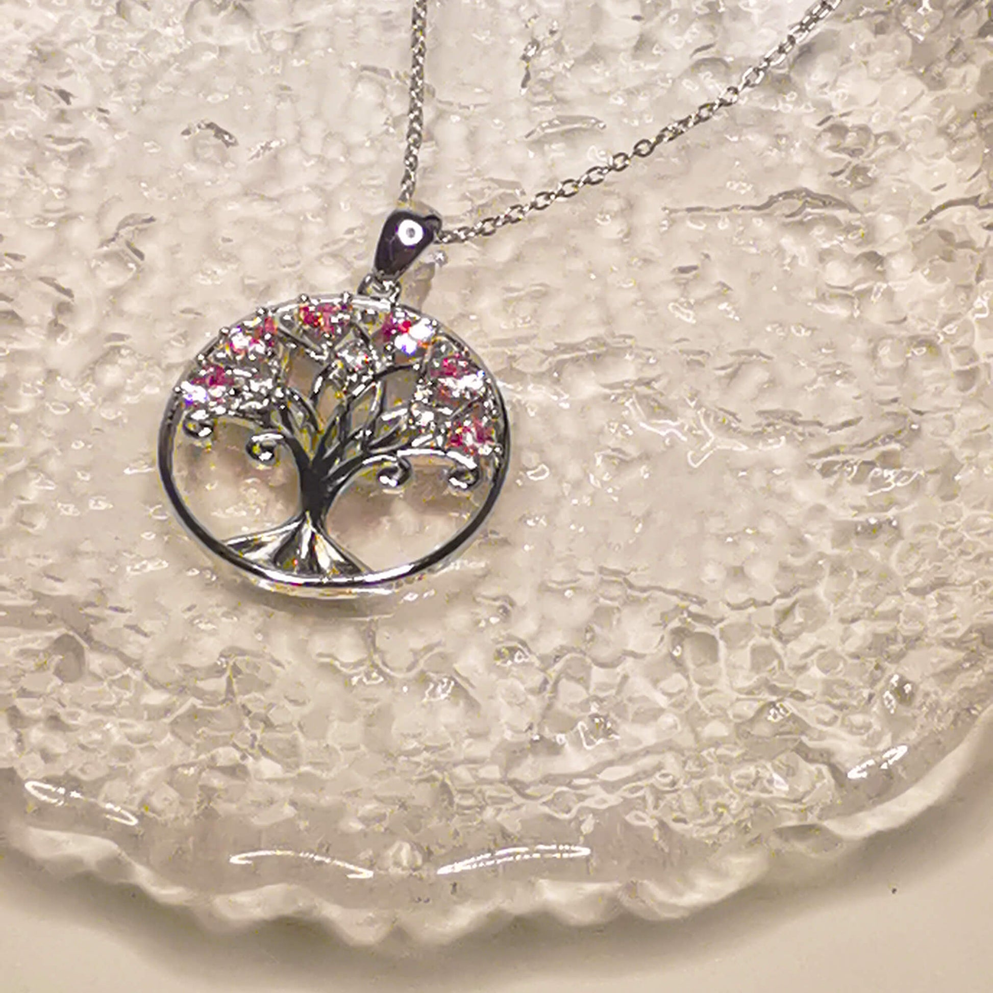 925 sterling silver tree of life pendant necklace featuring pink zircon stones.   Beautiful unique and meaningful gift for family.